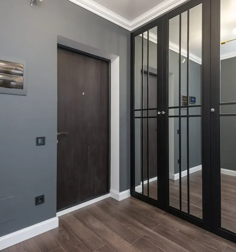 a room with a door and glass doors